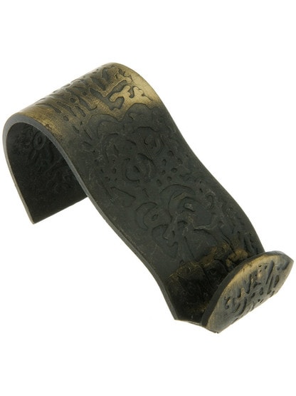 Ornate Floral Pattern Picture Rail Hook in Antique Brass.